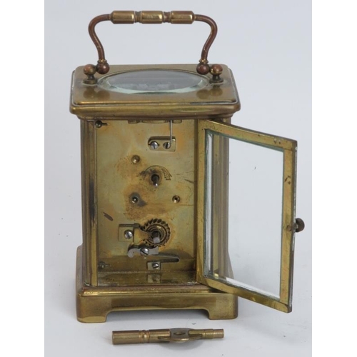 91 - An antique gilt brass carriage clock, late 19th/early 20th century. With a white enamelled Roman num... 