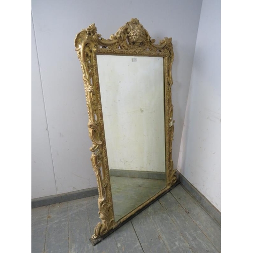 714 - A large 19th century bevelled overmantle mirror, within an orate gilt gesso frame modelled as fruit ... 