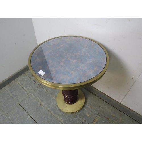 717 - A vintage brass side table, with bevelled mirror top, on a composite pedestal with a riveted brass p... 