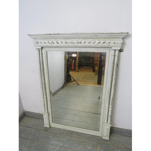 722 - An antique bevelled overmantle mirror, painted grey and distressed, with moulded cornice and twin re... 