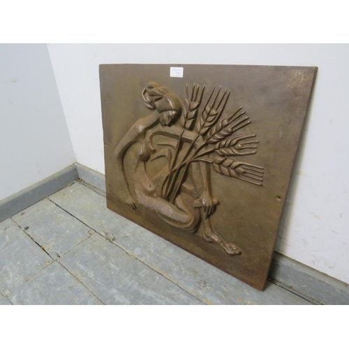 724 - An Art Deco Revival bronzed cast iron plaque/fireback depicting a stylized figure of a woman holding... 