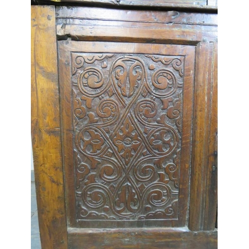 741 - A 17th century oak court cupboard of small proportions, having inverted finials above three cupboard... 