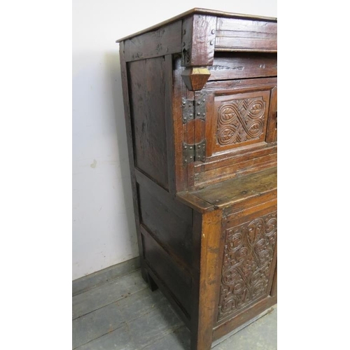 741 - A 17th century oak court cupboard of small proportions, having inverted finials above three cupboard... 