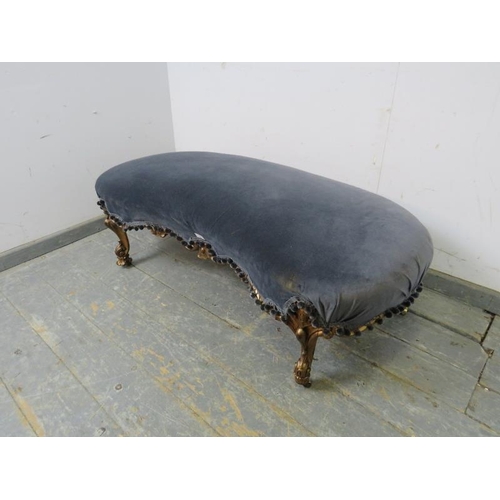 765 - An antique French giltwood kidney-shaped ottoman, re-covered in grey velvet material with pom-pom fr... 