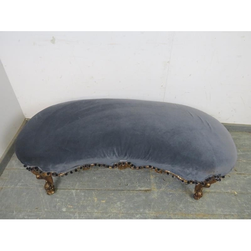 765 - An antique French giltwood kidney-shaped ottoman, re-covered in grey velvet material with pom-pom fr... 