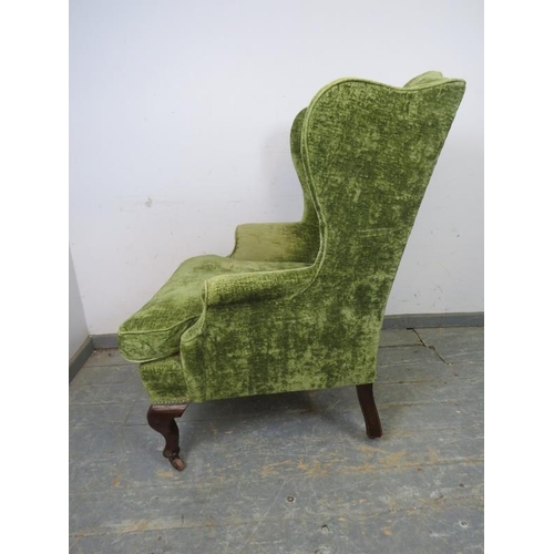 768 - A 19th century wingback armchair, recovered in jade green distressed velvet, on mahogany ogee suppor... 