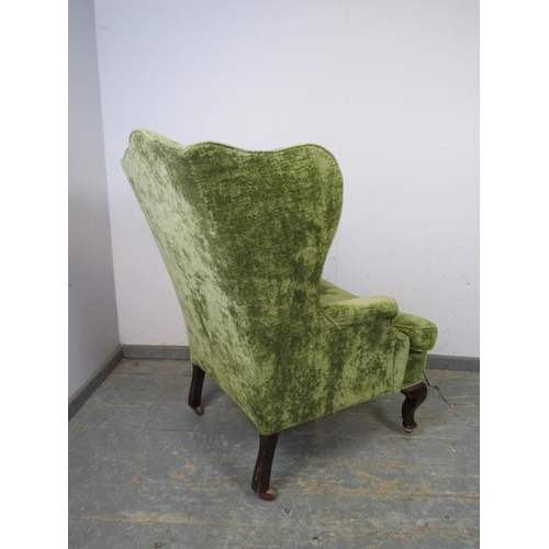 768 - A 19th century wingback armchair, recovered in jade green distressed velvet, on mahogany ogee suppor... 