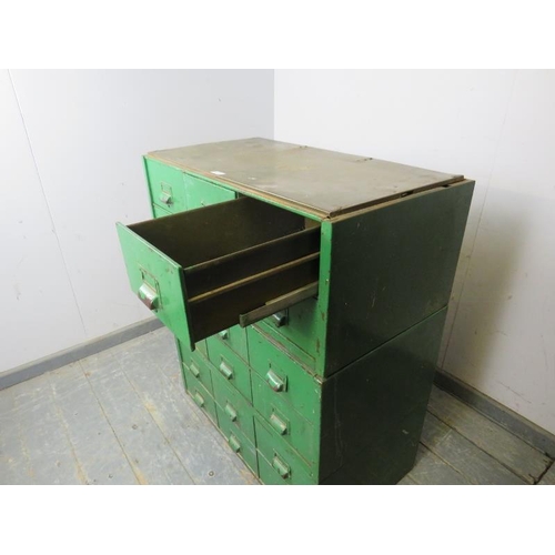 776 - A vintage industrial steel bank of 18 drawers, having scalloped handles and name plate holders, pain... 