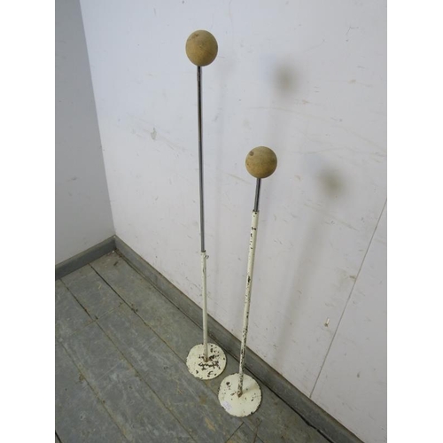 777 - A matched pair of vintage steel and chrome shop display hat stands, with cork ball tops, on circular... 