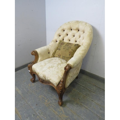 780 - A Victorian walnut button-backed armchair, reupholstered in cream damask, on scrolled supports. 
H91... 