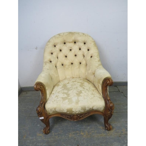 780 - A Victorian walnut button-backed armchair, reupholstered in cream damask, on scrolled supports. 
H91... 