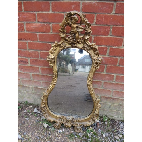 783 - A 19th century Rococo style wall mirror, the ornate gilt gesso frame with cornice modelled as Putti ... 