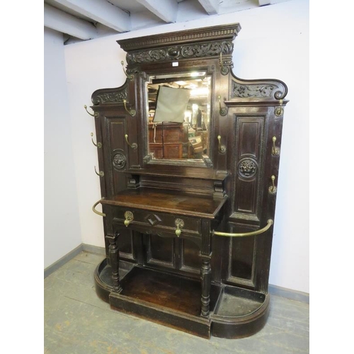 789 - A Victorian ebonised oak hallstand, the stepped cornice above an acanthus carved frieze, the bevelle... 