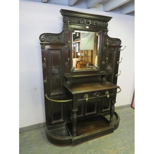 789 - A Victorian ebonised oak hallstand, the stepped cornice above an acanthus carved frieze, the bevelle... 