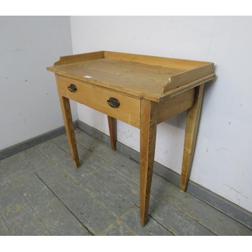 791 - An antique pine Continental washstand, the ¾ gallery above one long drawer with pressed brass handle... 