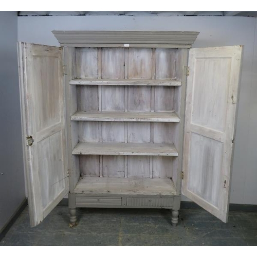 793 - An antique hardwood enclosed bookcase on stand, the double doors with carved panels opening onto thr... 