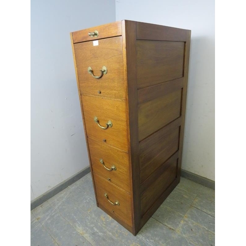 802 - An early 20th century mahogany tall filing cabinet, housing three deep drawers with brass bail handl... 