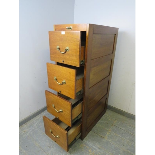 802 - An early 20th century mahogany tall filing cabinet, housing three deep drawers with brass bail handl... 