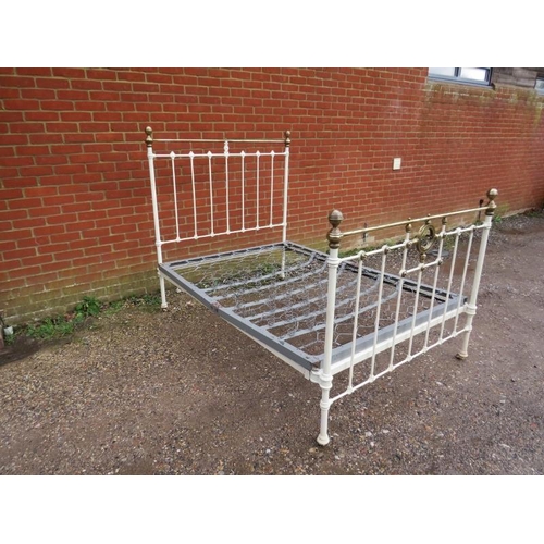 808 - An Edwardian brass double bed painted cream, with sprung mattress base, on brass and ceramic castors... 