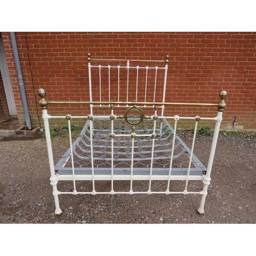 808 - An Edwardian brass double bed painted cream, with sprung mattress base, on brass and ceramic castors... 