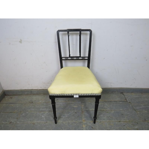 810 - An Aesthetic Movement ebonised boudoir chair, reupholstered in pale yellow satin, on tapering reeded... 