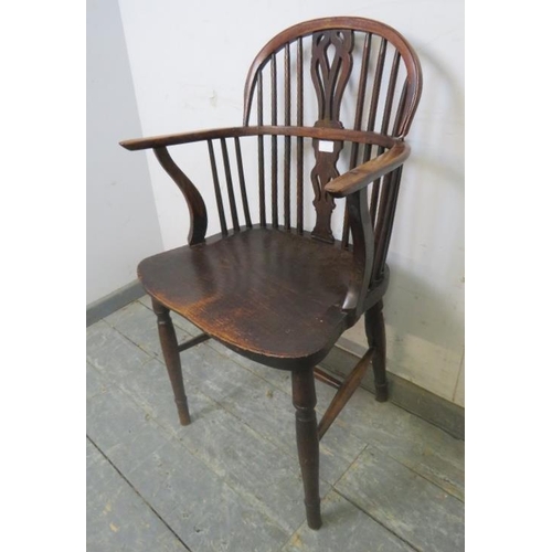 816 - A 19th century elm and yew wood Windsor armchair, having shaped and pierced splat, on turned support... 