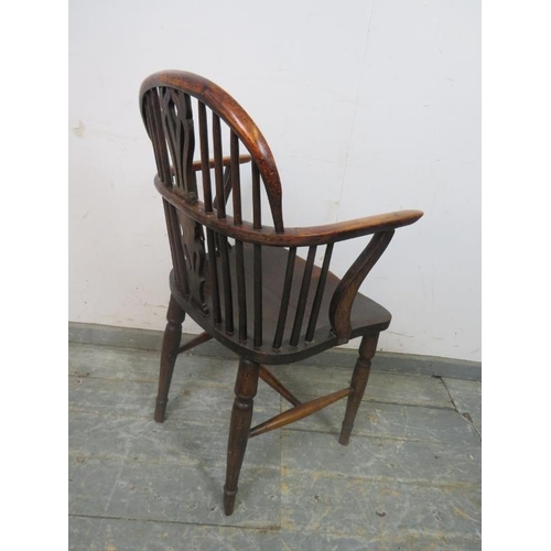 816 - A 19th century elm and yew wood Windsor armchair, having shaped and pierced splat, on turned support... 