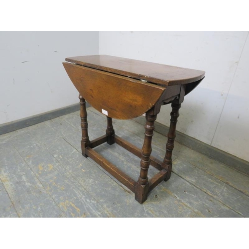 817 - A small 18th century style oak drop leaf table in the manner of Titchmarsh & Goodwin, on turned and ... 