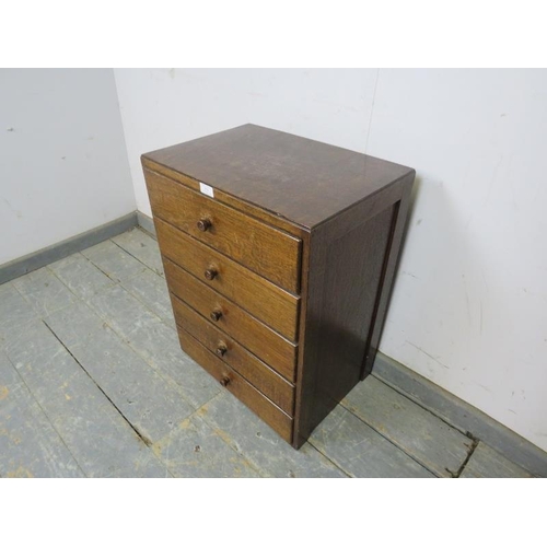 818 - Maritime interest: A small vintage oak chest housing five long drawers, the bottom drawer with brass... 