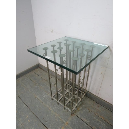 820 - An artisan made contemporary side table, the toughened glass top on a cluster column steel base. 
H7... 