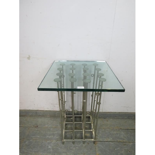 820 - An artisan made contemporary side table, the toughened glass top on a cluster column steel base. 
H7... 