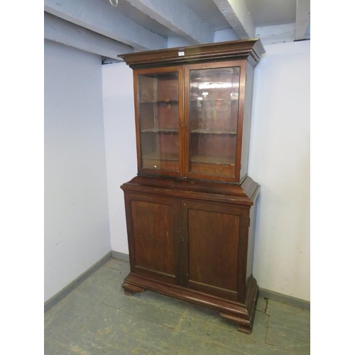 822 - A George III mahogany apothecarists cabinet, the glazed top section with fitted shelves retaining in... 