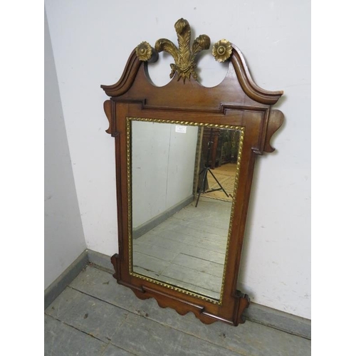 825 - An antique Georgian Revival wall mirror, the broken swan-neck pediment with Prince of Wales feather ... 