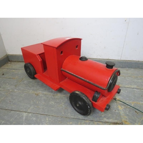 827 - A vintage scratch-built child’s pull along toy train, painted bright red. 
H33cm W76cm D24cm approx.... 