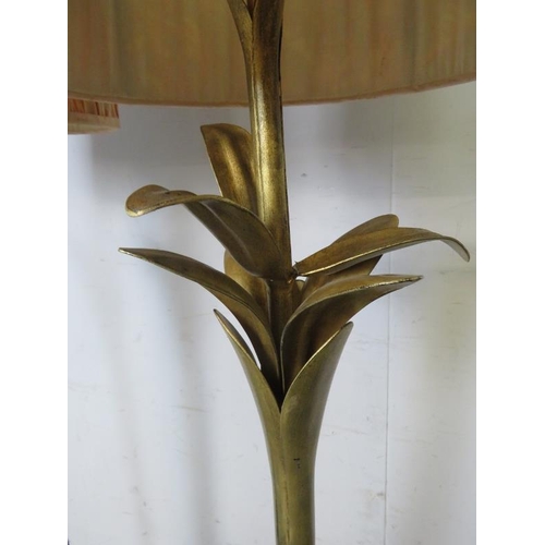 828 - A pair of gilt metal floor lamps, the naturalistic columns on splayed tripod supports. Including sha... 