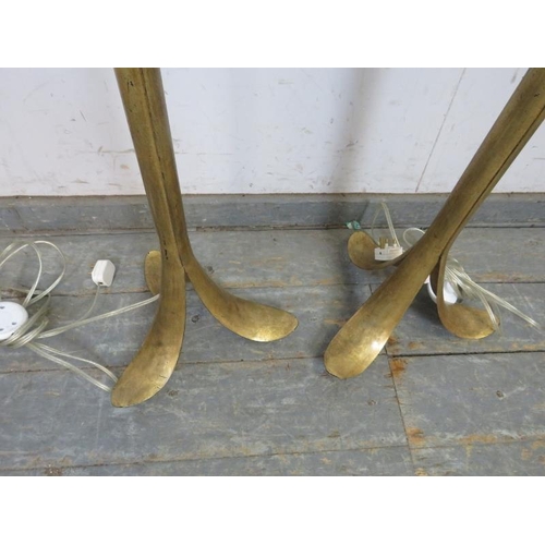 828 - A pair of gilt metal floor lamps, the naturalistic columns on splayed tripod supports. Including sha... 