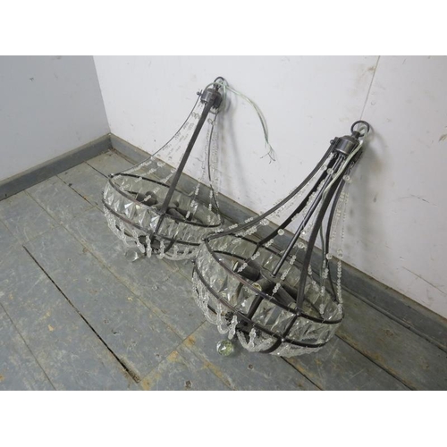 841 - A pair of burnished metal and glass basket chandeliers in the Classical taste, each accepting six sm... 