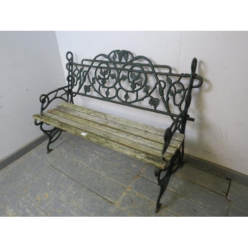 849 - A vintage cast iron garden bench in the manner of Coalbrookdale, the naturalistic back and sides wit... 