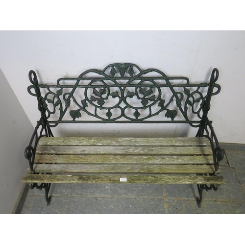 849 - A vintage cast iron garden bench in the manner of Coalbrookdale, the naturalistic back and sides wit... 