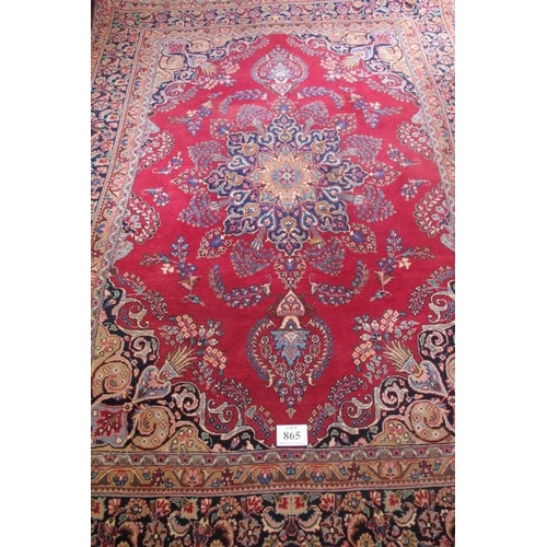 865 - 20th Century Persian Tabriz carpet.  Central motif blue on red ground with wide borders. 330cm x 235... 