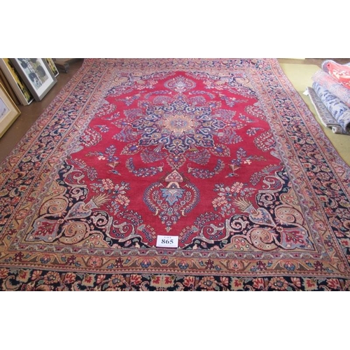 865 - 20th Century Persian Tabriz carpet.  Central motif blue on red ground with wide borders. 330cm x 235... 