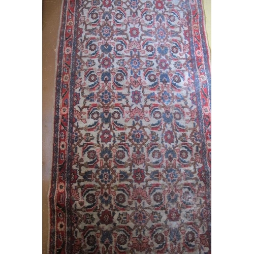 867 - A 20th Century Persian runner, repeat pattern on fawn ground. 480cm x 95cm approx.
Condition report:... 