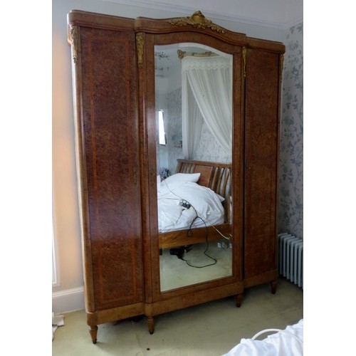 726 - An antique French burr walnut breakfront armoire, having crossbanded inlay and gilt metal mounts, th... 