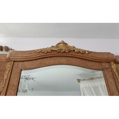 726 - An antique French burr walnut breakfront armoire, having crossbanded inlay and gilt metal mounts, th... 