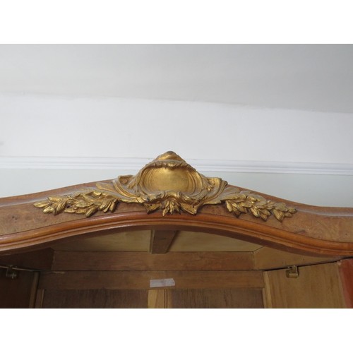 726 - An antique French burr walnut breakfront armoire, having crossbanded inlay and gilt metal mounts, th... 