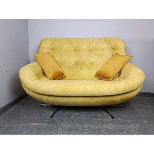 729 - A mid-century two-seater sofa/loveseat, reupholstered in buttoned yellow velvet material, on splayed... 