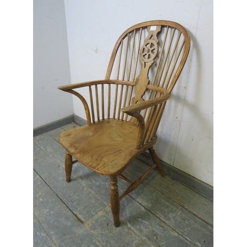 750 - A 19th century pale elm and beech Windsor wheelback chair, on turned supports with an ‘H’ stretcher.... 