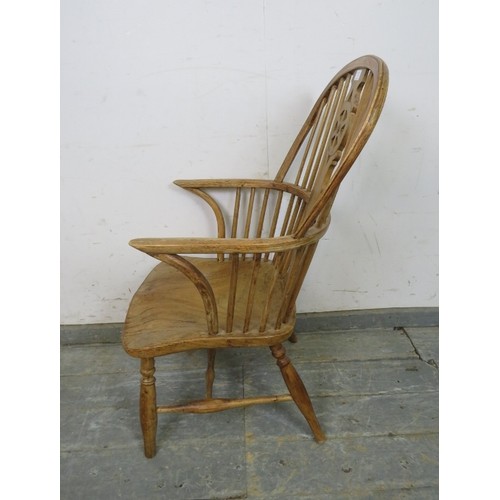 750 - A 19th century pale elm and beech Windsor wheelback chair, on turned supports with an ‘H’ stretcher.... 