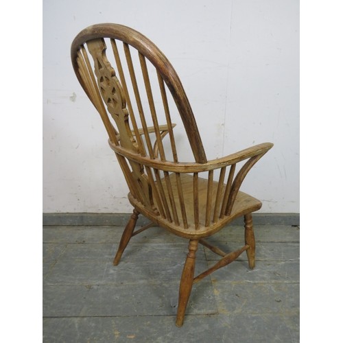 750 - A 19th century pale elm and beech Windsor wheelback chair, on turned supports with an ‘H’ stretcher.... 