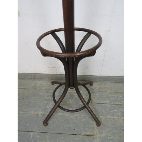 752 - An antique bentwood hat stand, having six double hooks above divided stick stand compartments, on sp... 